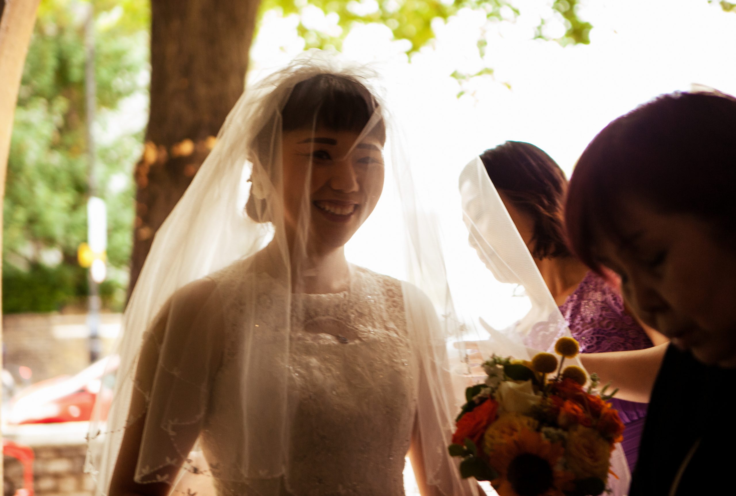 Close up of bride smiling under her veil