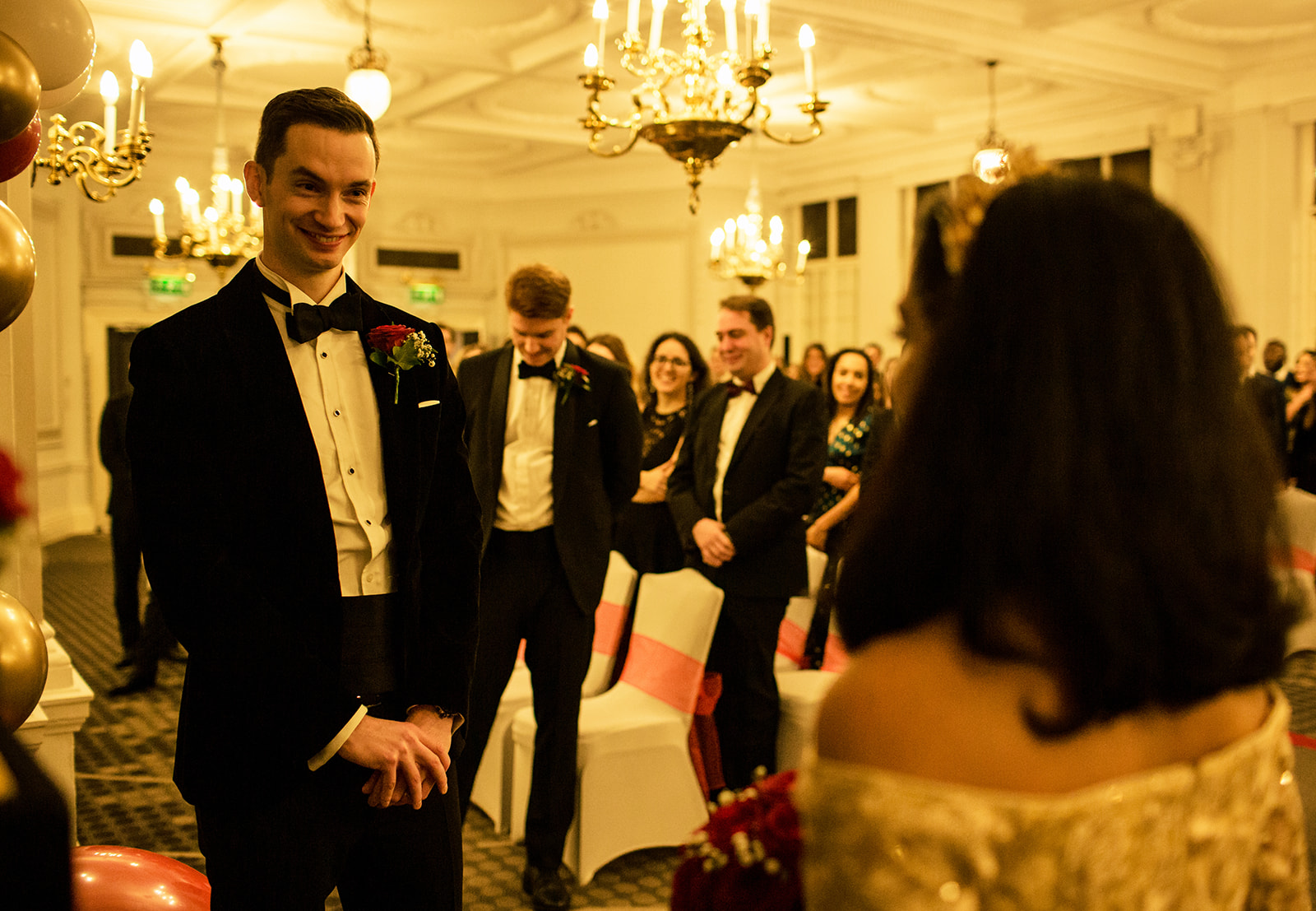 Groom-smiling-at-the-alter-looking-at-the-bride