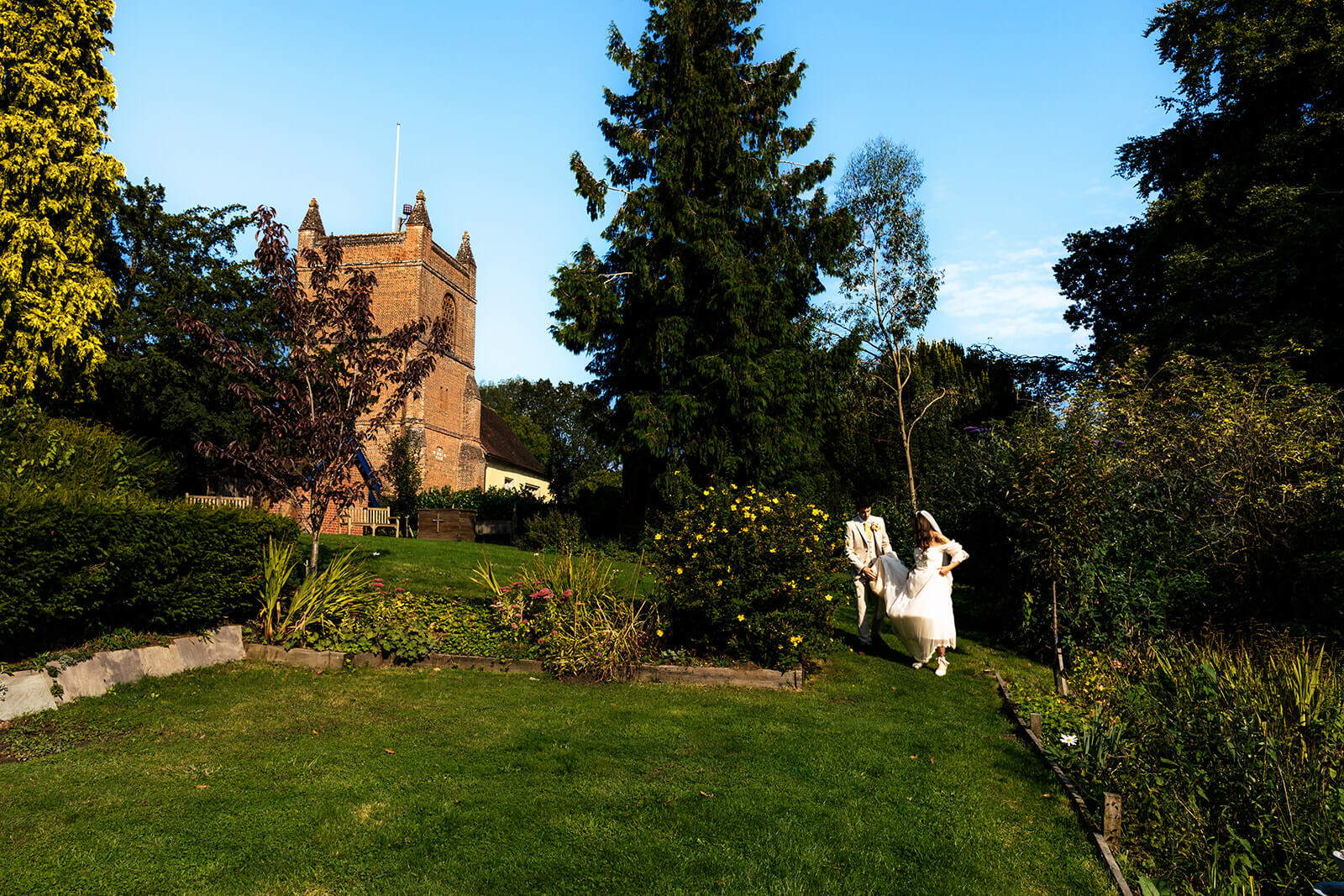 Bride and Groom walking on Church grounds in Wokingham