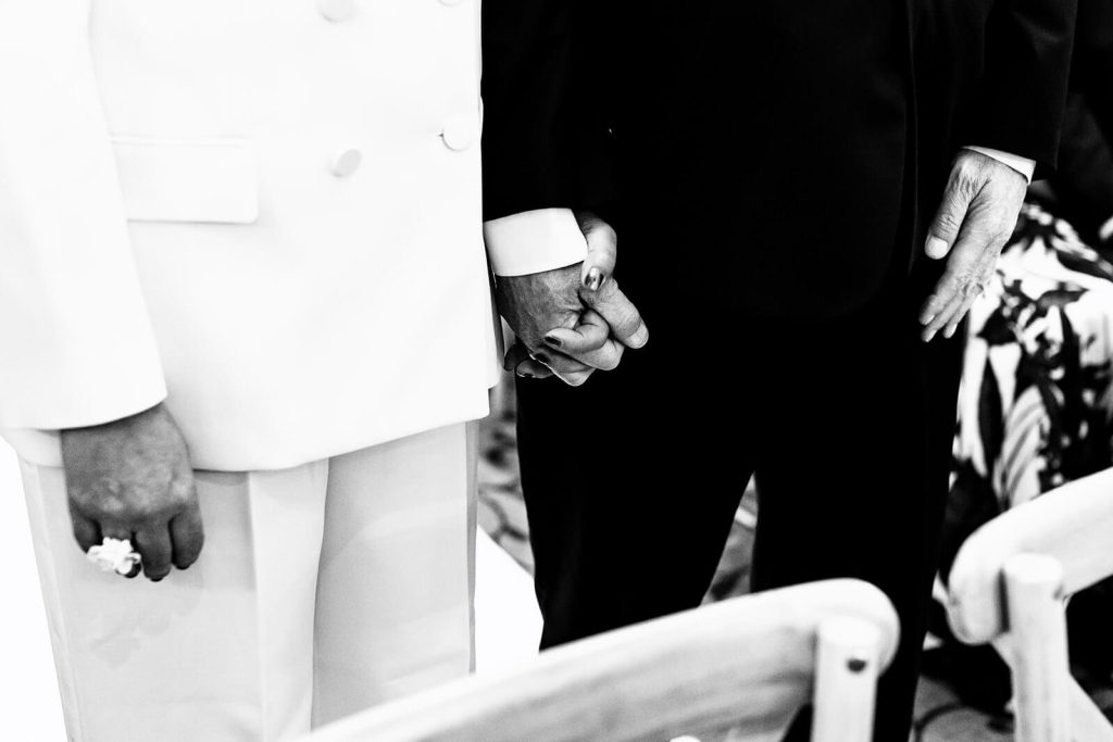 bride and groom holding hands